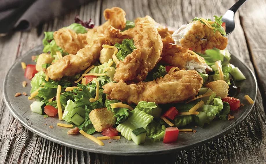 Farm-Fresh Field Greens with Crispy Chicken Tenders - Entrée Salads Farm-Fresh Field Greens with Crispy Chicken Tenders - Entrée Salads on LongHorn Steakhouse menu